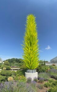 Tall glass sculpture in botanical garden
