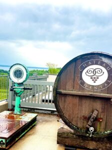 Wooden wine barrel at winery overlooking scenery.