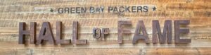 Green Bay Packers Hall of Fame sign on wood