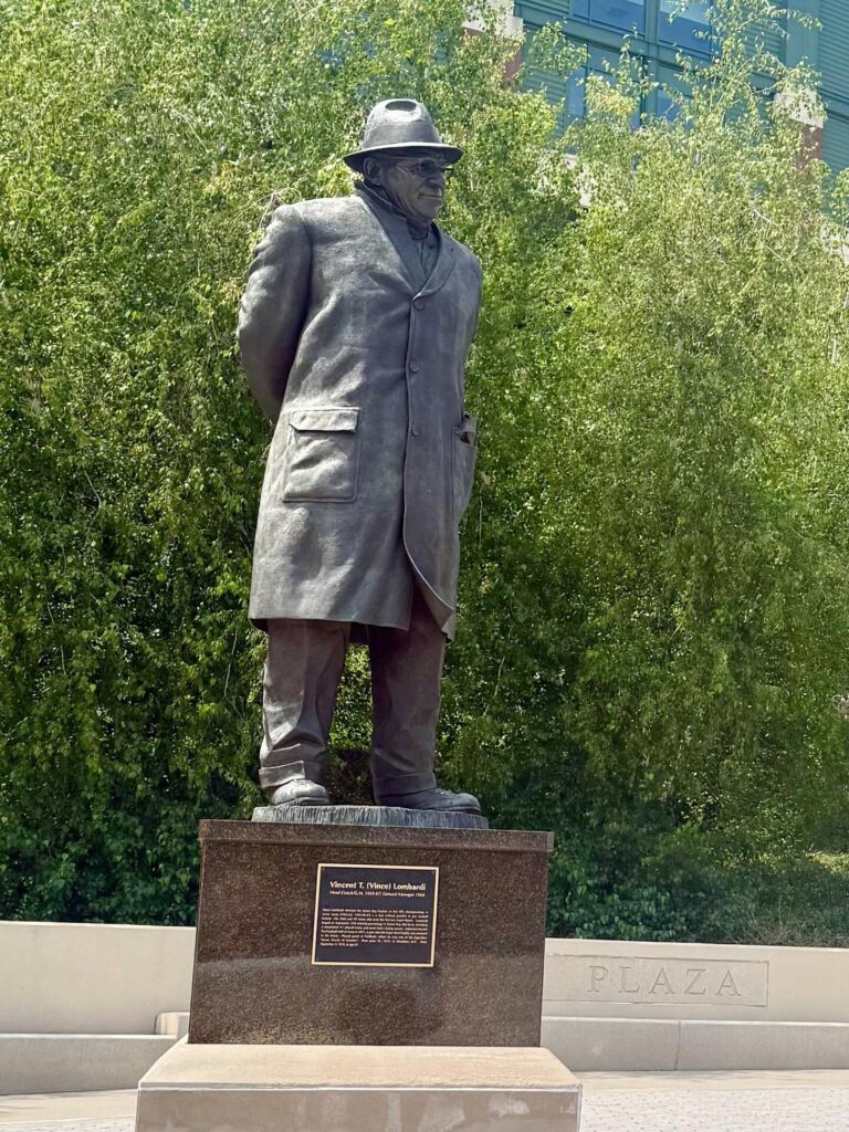 Statue of a man in a coat and hat.