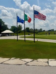 Golf course with three flags and pavilion.