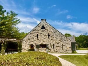 Stone building with greenery and blue sky.