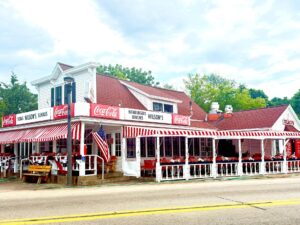 Diner with red-striped awning and Coca-Cola signs.
