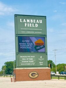 Lambeau Field entrance sign and attractions list.