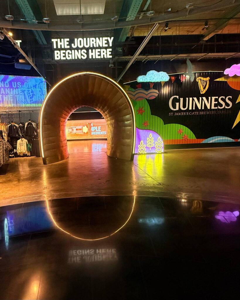 Guinness brewery entrance with illuminated tunnel.