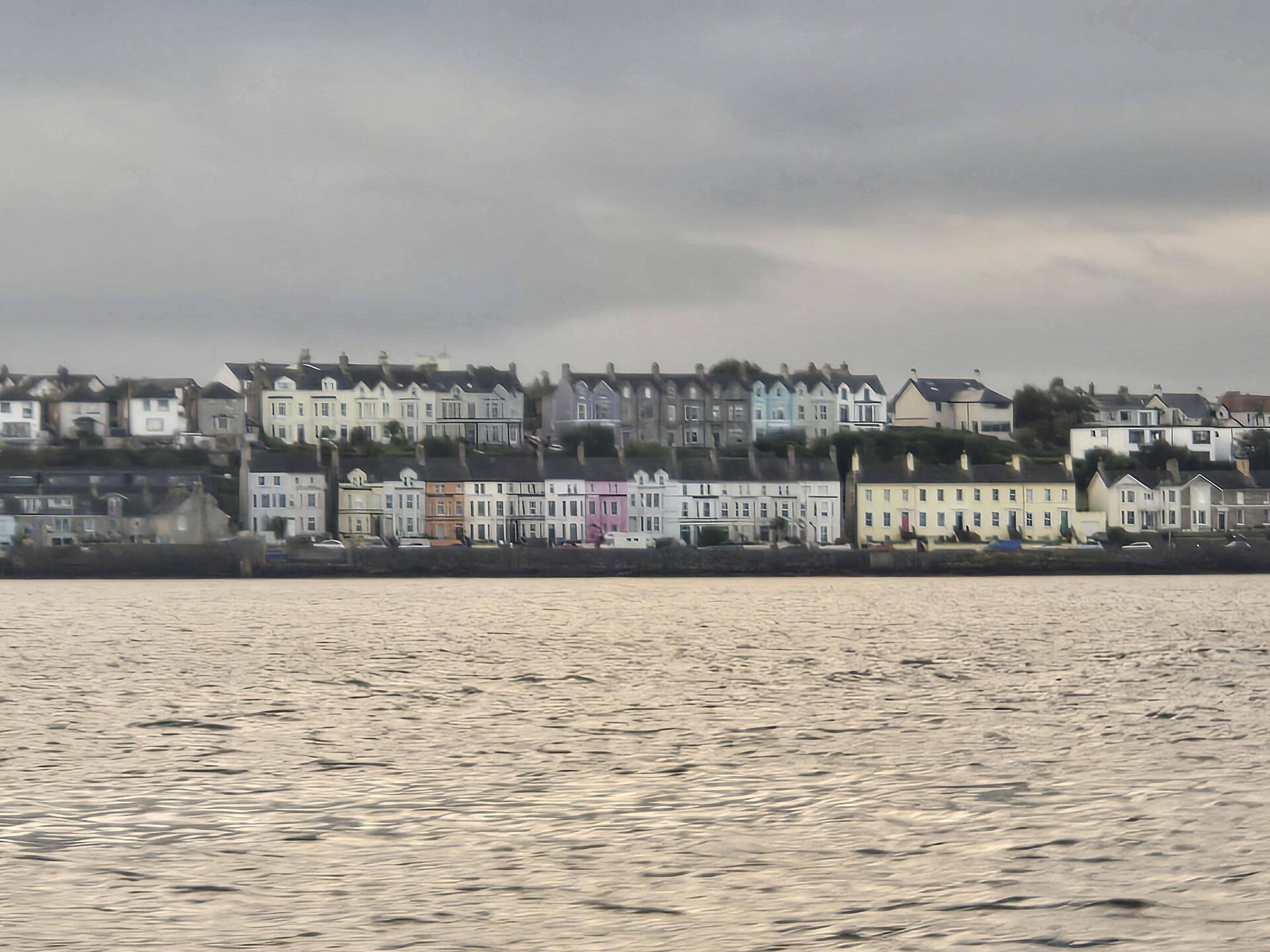 Seaside townhouses under cloudy sky