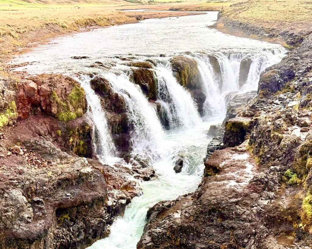 Scenic waterfall flowing over rocky cliffs
