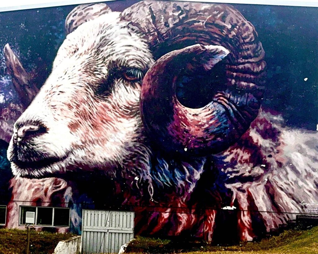 Colorful ram mural on building wall