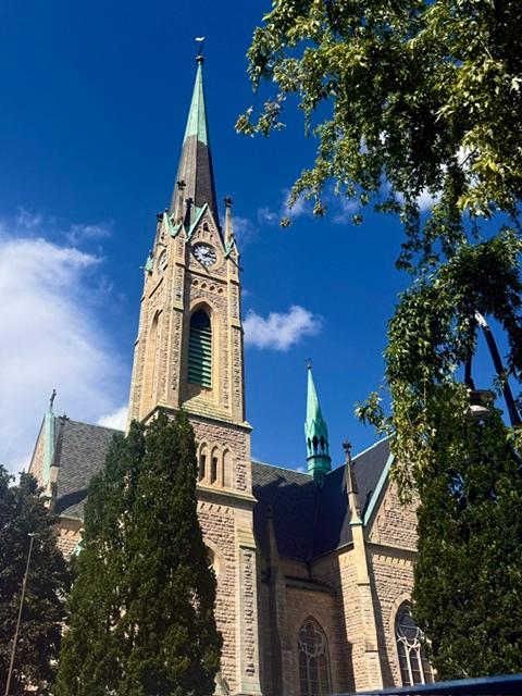 Historic church with tall steeple and clock tower.