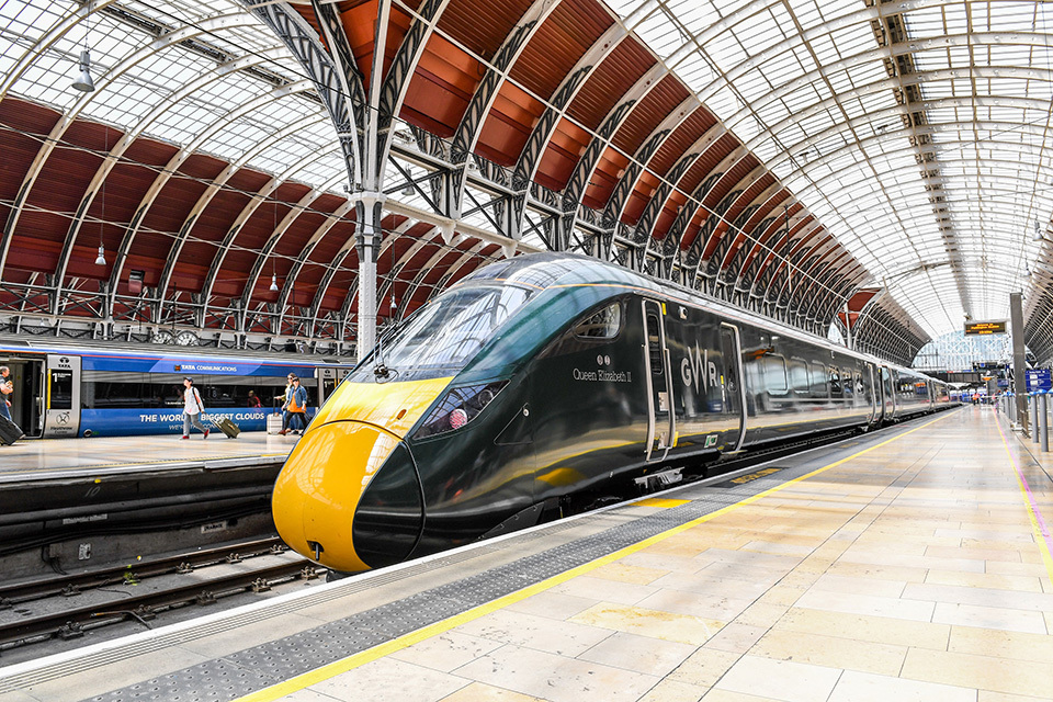 Modern train at spacious railway station platform.