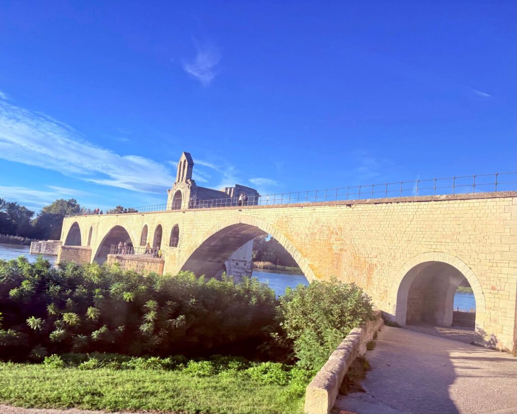 Historical stone bridge over a river with arches.