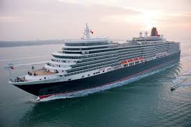 Large cruise ship sailing at sunset.