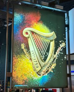 Colorful harp sign with 'ESTD. 1759' text.