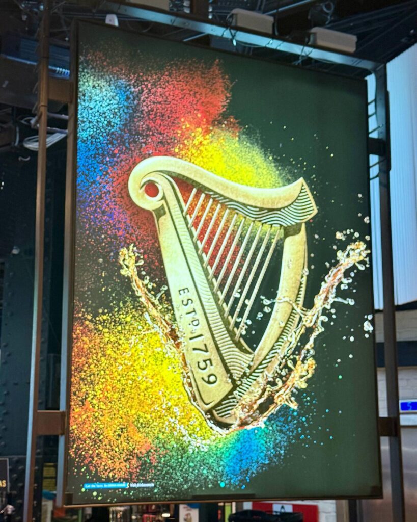 Colorful harp sign with 'ESTD. 1759' text.