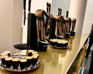 Guinness taps and glasses on bar counter.