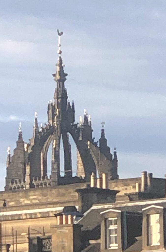 Gothic church spire against blue sky backdrop.
