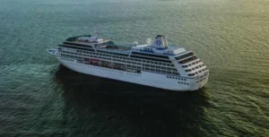 Cruise ship at sunset on the ocean.